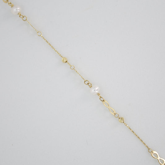 Pulsera infinitos con perla en oro amarillo 14k.