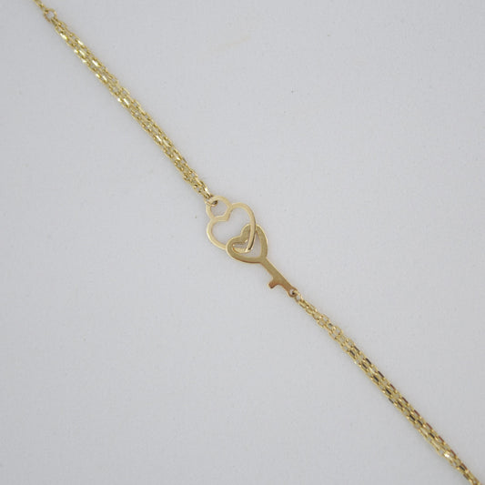 Pulsera corazón con llave en oro amarillo 14k.