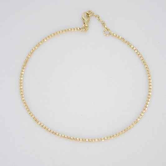 Pulsera rígida de bolitas en oro amarillo 14k.