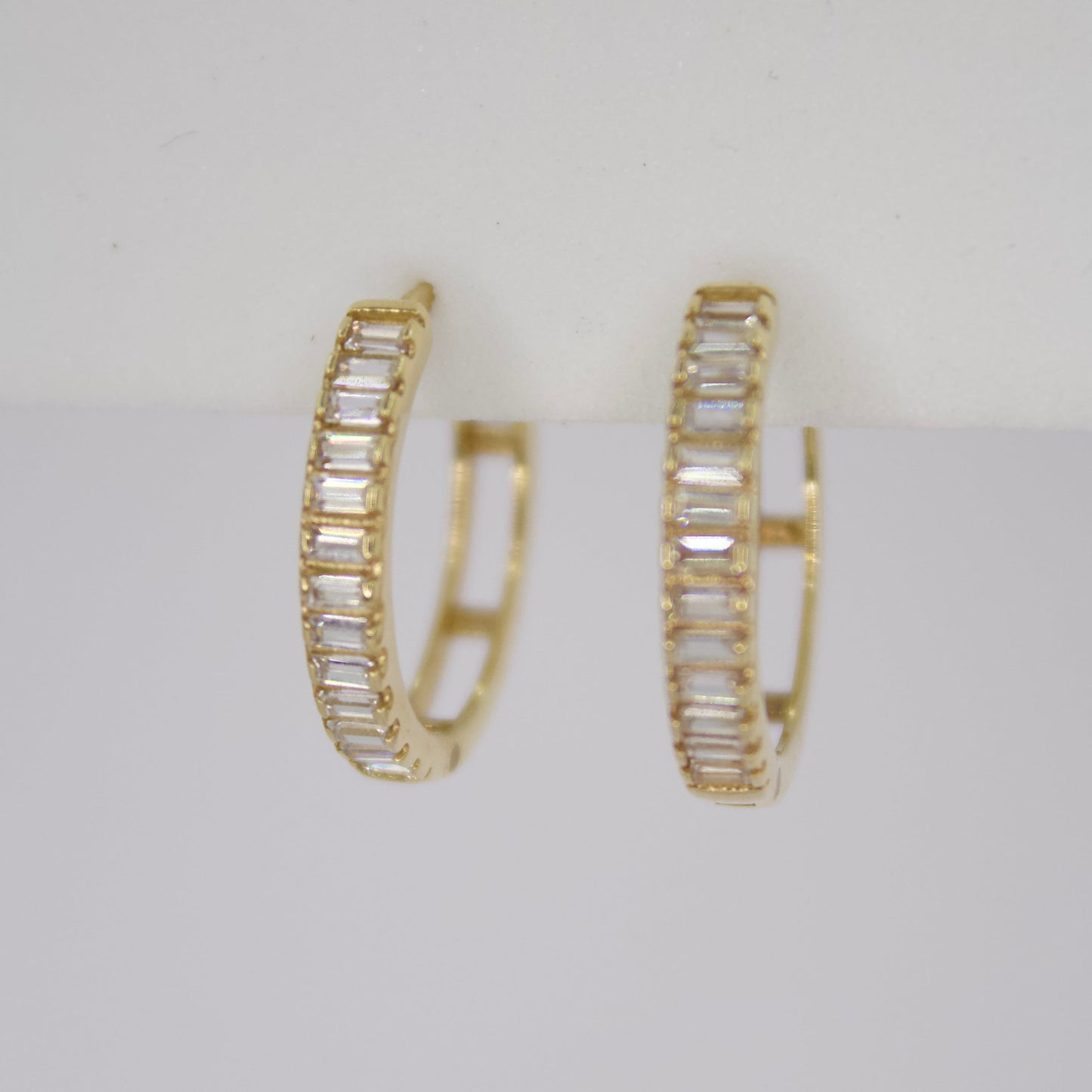 Aretes Huggies en oro amarillo 14k con zirconias.